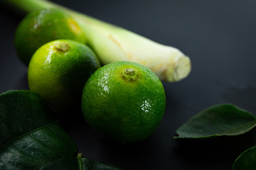 Lime and lemongrass in black background