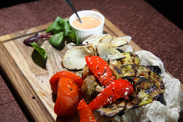 Grilled vegetables with smoked sauce. Baked tomatoes, eggplants, zucchini, sweet peppers and onions.