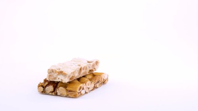 Half frame cutted traditional spanish dessert Turron. Rotating on on white background. Isolated. Close up macro. Loopable.