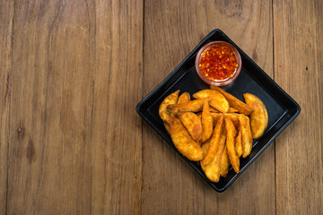 French fries, chips, finger chips are cut deep-fried potatoes,Common fast food served with tomato sauce, ketchup, vinegar, mayonnaise