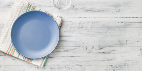 Empty purple plate on wooden background