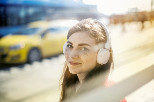 Smiling girl with white headphones