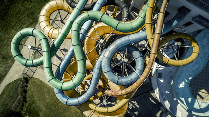 Aerial view from drone on tubes in the water park. They are colorful.