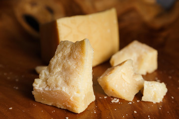 Parmesan cheese on a wooden board. Close-up.