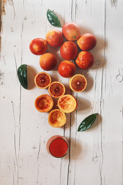 Concep of orange juice over a white wooden table
