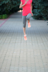 Obraz na płótnie Canvas Girl Stretching Her Legs and preparing for a marathon