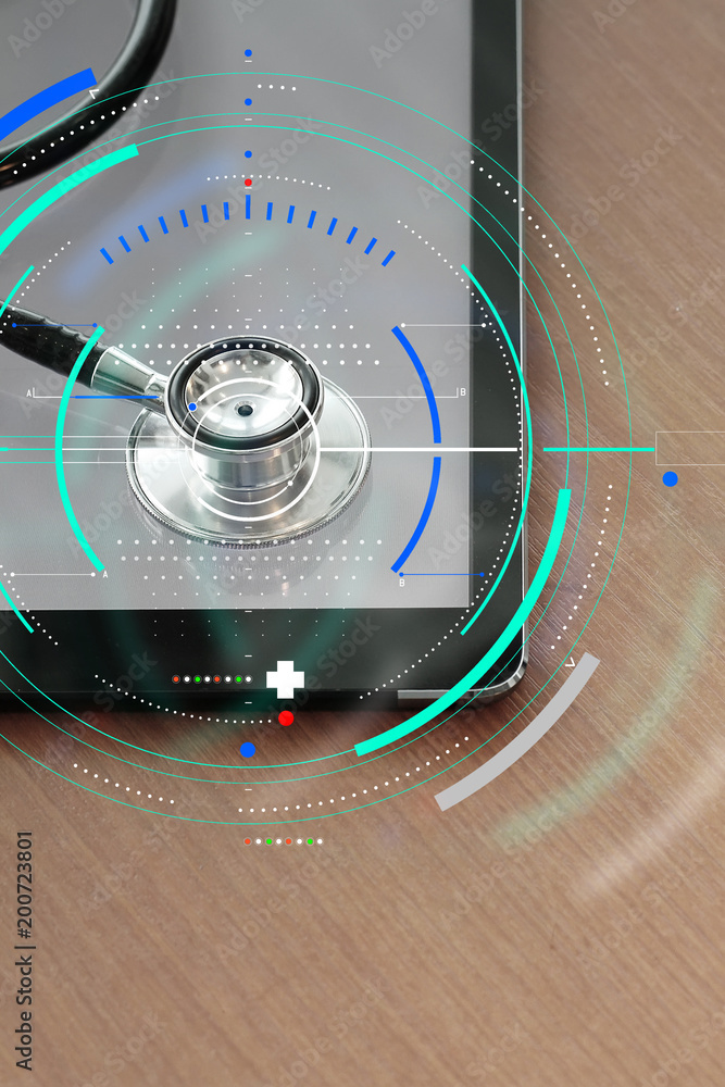 Poster stethoscope with digital tablet computer on wooden table and background