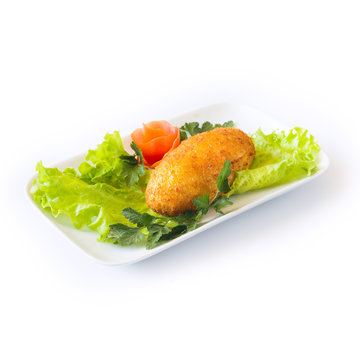 Chicken cutlet with herbs on a white plate. Isolated