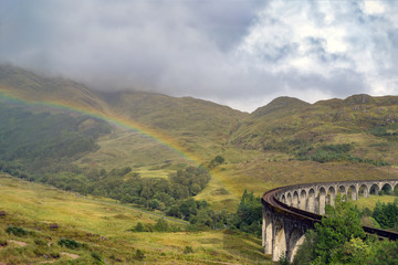 Lake and fishermen boat near famous Glenfinnan Railway Viaduct in Scotland