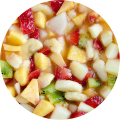 closeup of real organic fruit salad, circle shape of fresh food with juice