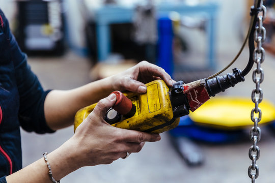 Woman with tools in a mechanical garage