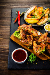 Roast chicken wings with baked potatoes