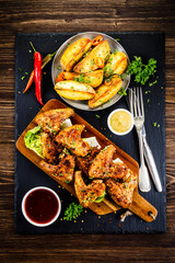 Roast chicken wings with baked potatoes
