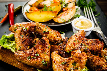 Roast chicken wings with baked potatoes