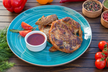 Grilled meat with baked potato and spicy sauce