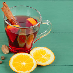 Hot red mulled wine on wooden background with spices. Free space for text.