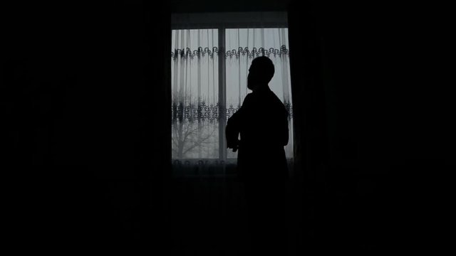 silhouette of a man dressed in the room