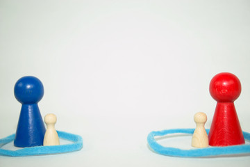 blue and small wooden figure on the left, red and small wooden figure on the right, systemic board,...