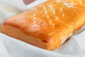 Yummy freshly baked pie is laid out on a white linen dish towel. Сlose-up shot.