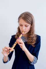 Girl playing on a flute © Nichizhenova Elena