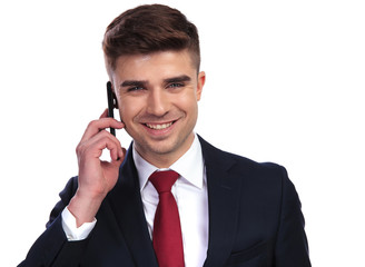 handsome laughing businessman is talking on the phone