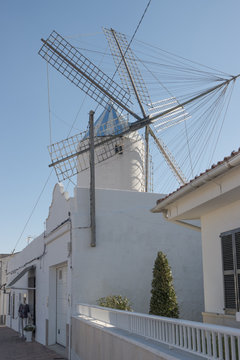 Street with windmill in Sant Lluis, Menorca, Balearic Islands, Spain