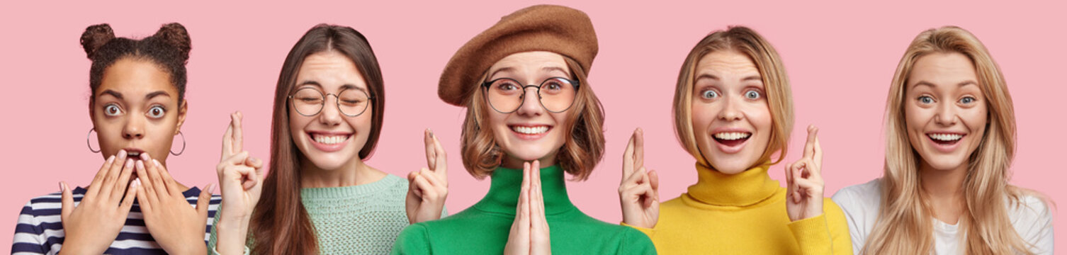 Young attractive women express different emotions, pose together against pink studio background. Shocked dark skinned female, Asian woman with desired look, lovely girl in beret pleads for something