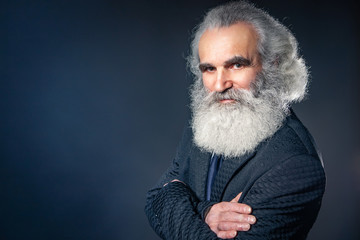 A man with a big beard. Gray beard. Karl Marx. An elderly man with a gray beard. Cheerful old man. Grandfather parodies Karl Marx.