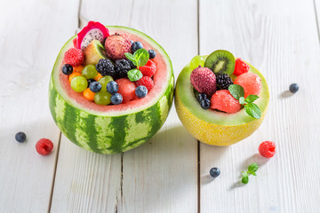Fruits salad in watermelon in summer on white table