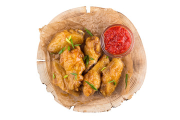 Appetizing chicken wings on a grill on a white background top view.