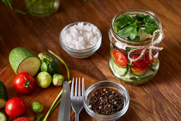 Fresh vegetable salad and ripe veggies on cutting board over wooden background, close up, selective focus