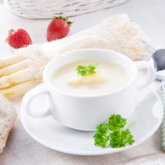asparagus cream soup with capers and fresh baguette