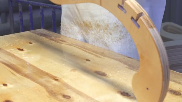 Industrial carpenter worker varnishing on wood