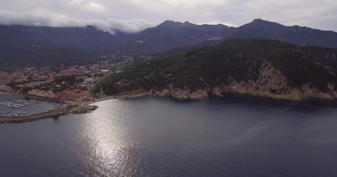 Aerial, beautiful bay and a little port of Marciana Marina on Elba island in Tuscany, Italy on a cloudy day