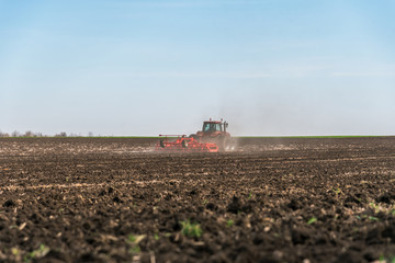Fototapeta premium Tractor plowing fields.