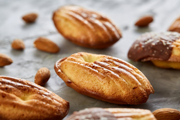 Tasty almond cookies arranged on white background, close-up, selective focus