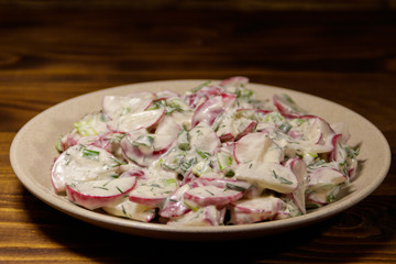 Spring salad with radish, dill and green onions and sour cream