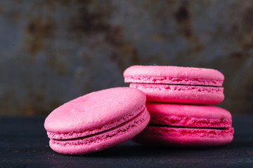 Pink french macaroons on rustic background