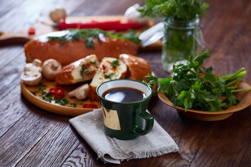 Country side still life with homemade pastries, coffee cup, herbs, vegetables over a vintage background, selective focus