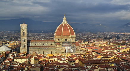Bright Maria del Fiore cathedral illuminated by sun rays between clouds