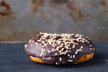Choco donut on rustic metal background