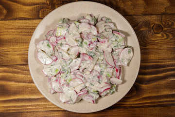 Spring salad with radish, dill and green onions and sour cream