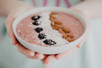 Crop person having delicious smoothie bowl