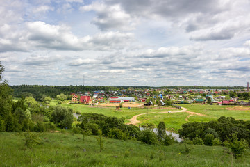 Fototapeta na wymiar View of the village of Krivskoye, Borovskoy district, Russia. View from the high bank of the Protva River 