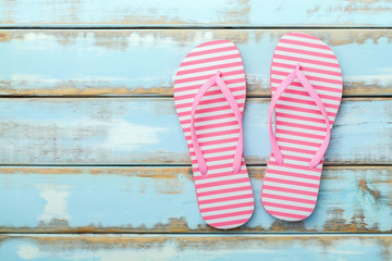 Pink Beach flip flop on white wooden floor