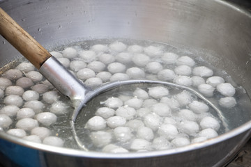 Cooking meat ball in hot pot.Boiled meat ball in hot water in asia tradition street market