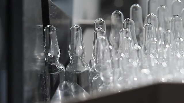 Close-up vaccine vials. Production of medicines on a modern conveyor.
