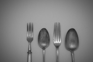 Vintage cutlery forks and spoons on an black  background