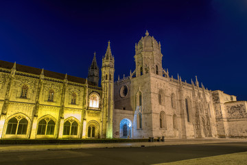 Fototapeta na wymiar Facade of the Jeronimos (Hieronymites) Monastery in the Belem district of Lisbon illuminated at night