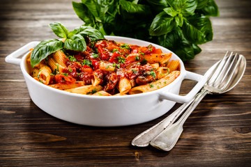 Penne with meat, tomato sauce and vegetables